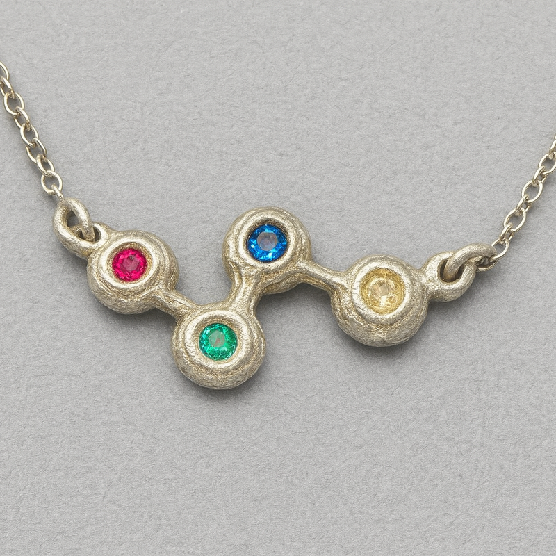 Necklace with colorful gemstones on a gray background