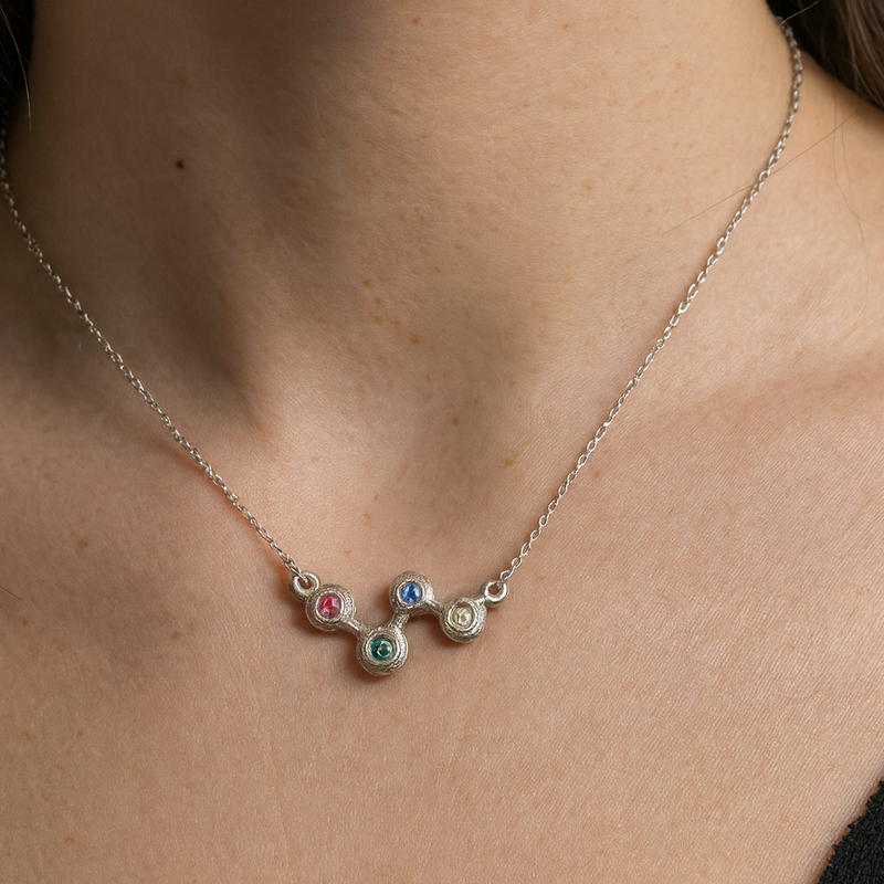 Necklace with colorful gemstones worn by a person