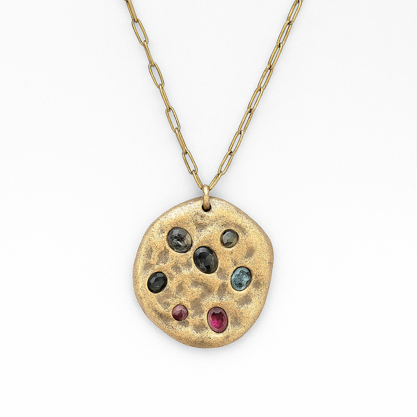 Necklace with a round pendant featuring embedded stones on a white background
