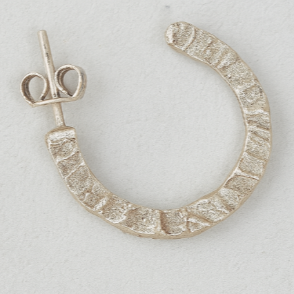 Silver hoop earrings on a light gray background