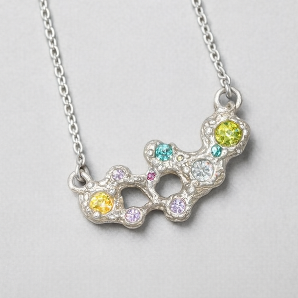 Necklace with a colorful pendant on a light gray background